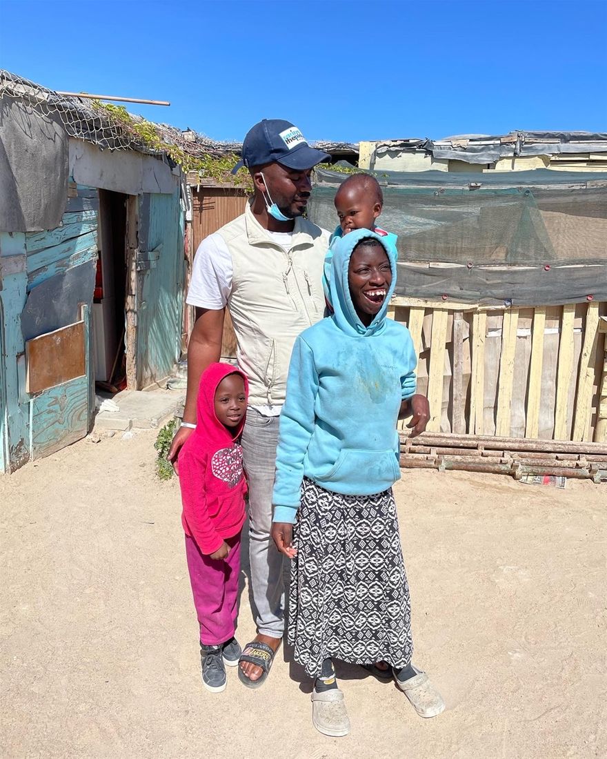 Clifton at his home with his neighbours children